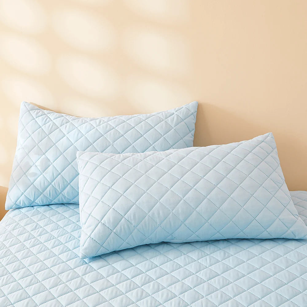 Waterproof Throw pillowcase demonstration with water being poured on a teal mattress pad.