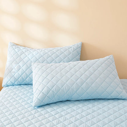 Waterproof Throw pillowcase demonstration with water being poured on a teal mattress pad.