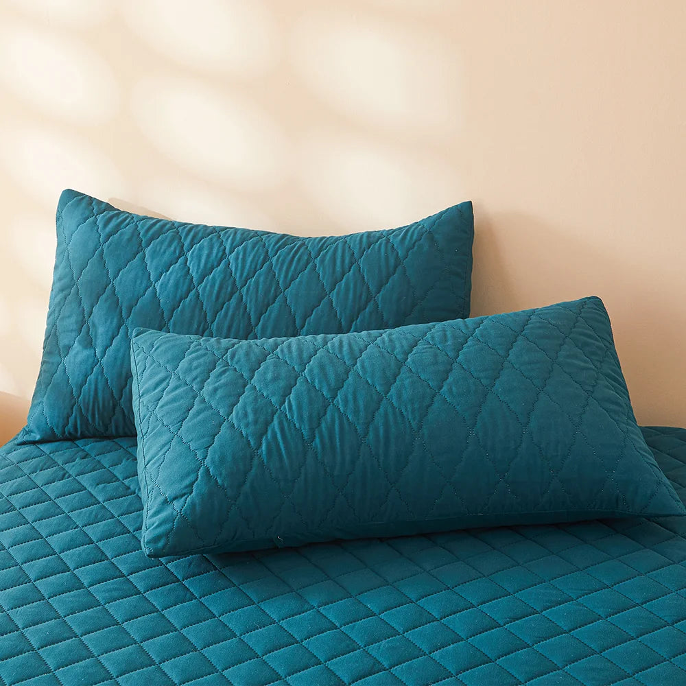 Waterproof Throw pillowcase demonstration with water being poured on a teal mattress pad.