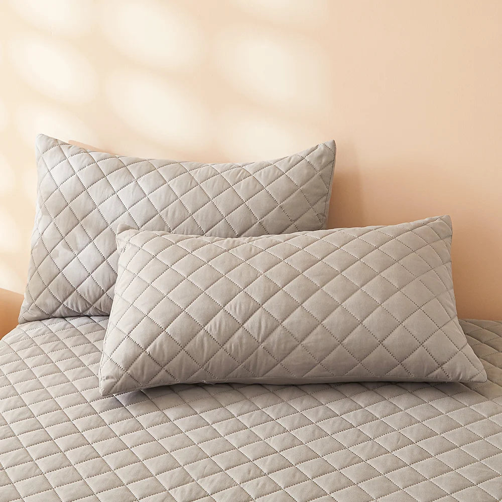 Waterproof Throw pillowcase demonstration with water being poured on a teal mattress pad.