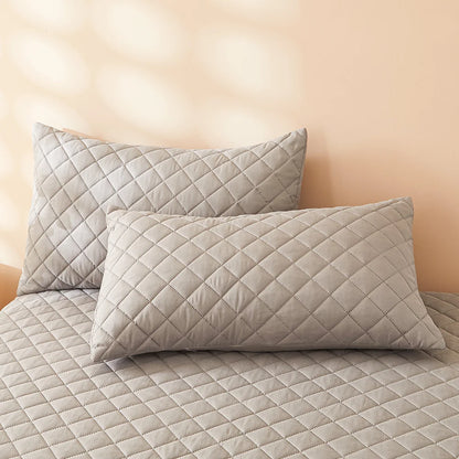 Waterproof Throw pillowcase demonstration with water being poured on a teal mattress pad.