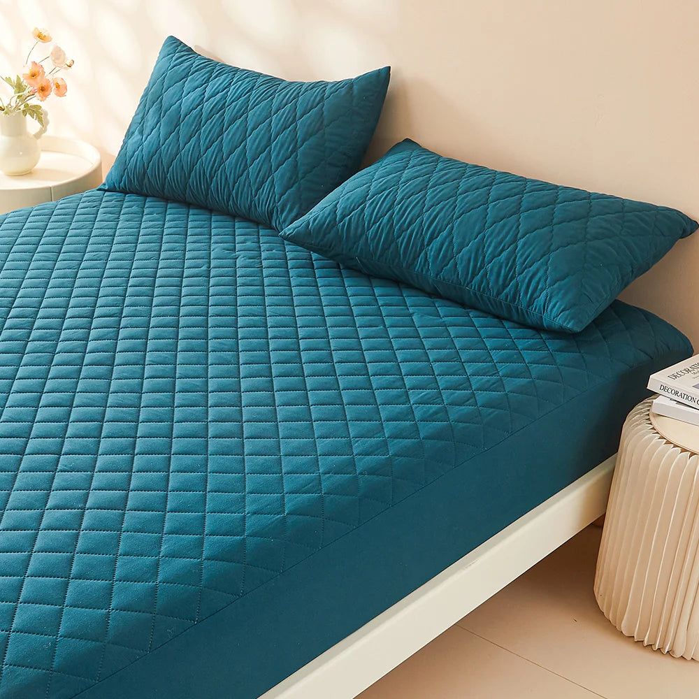 Waterproof Throw Pillowcases Envelope Soft Breathable on a cozy bed with teal quilted mattress and pillows.