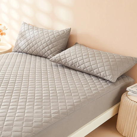 Waterproof Throw Pillowcases Envelope Soft Breathable on a cozy bed with quilted texture.