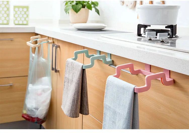 Hanging trash bag holder for cupboard door