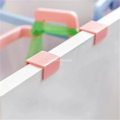 Hanging trash bag holder on kitchen cabinet